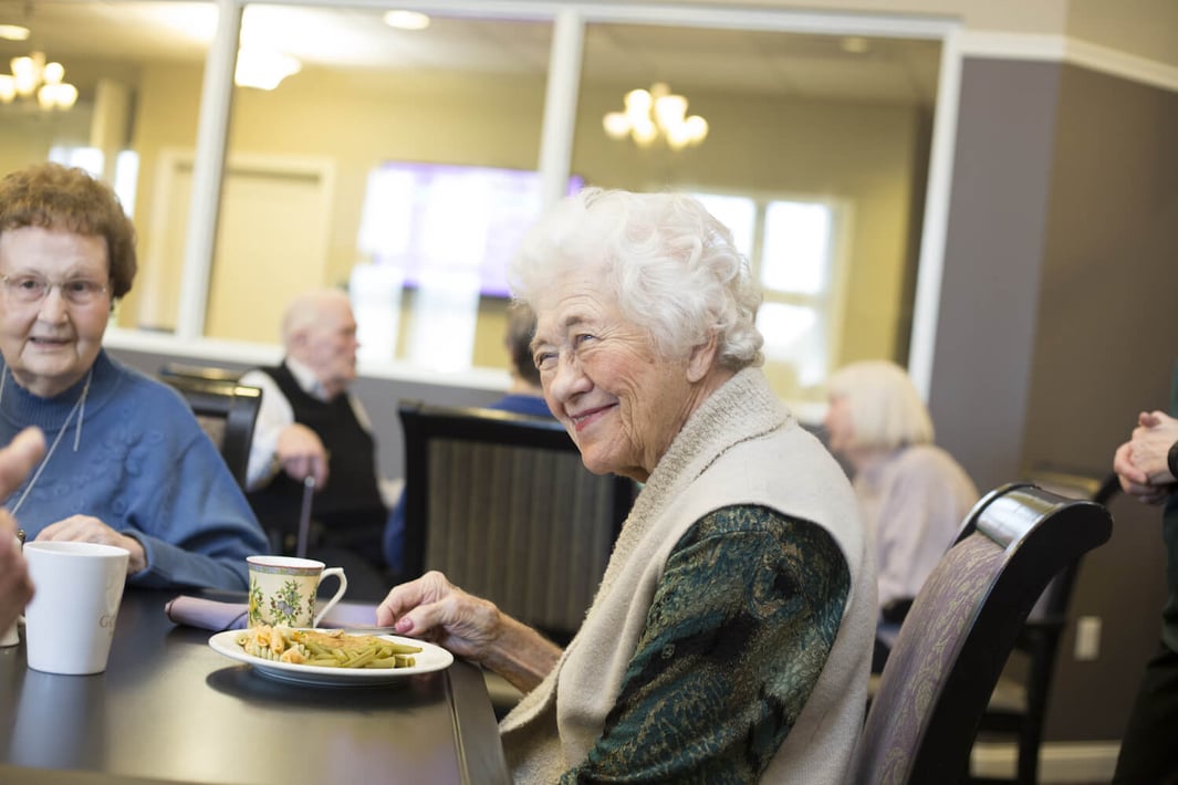 Senior lady enjoying dinner in the community restaurant