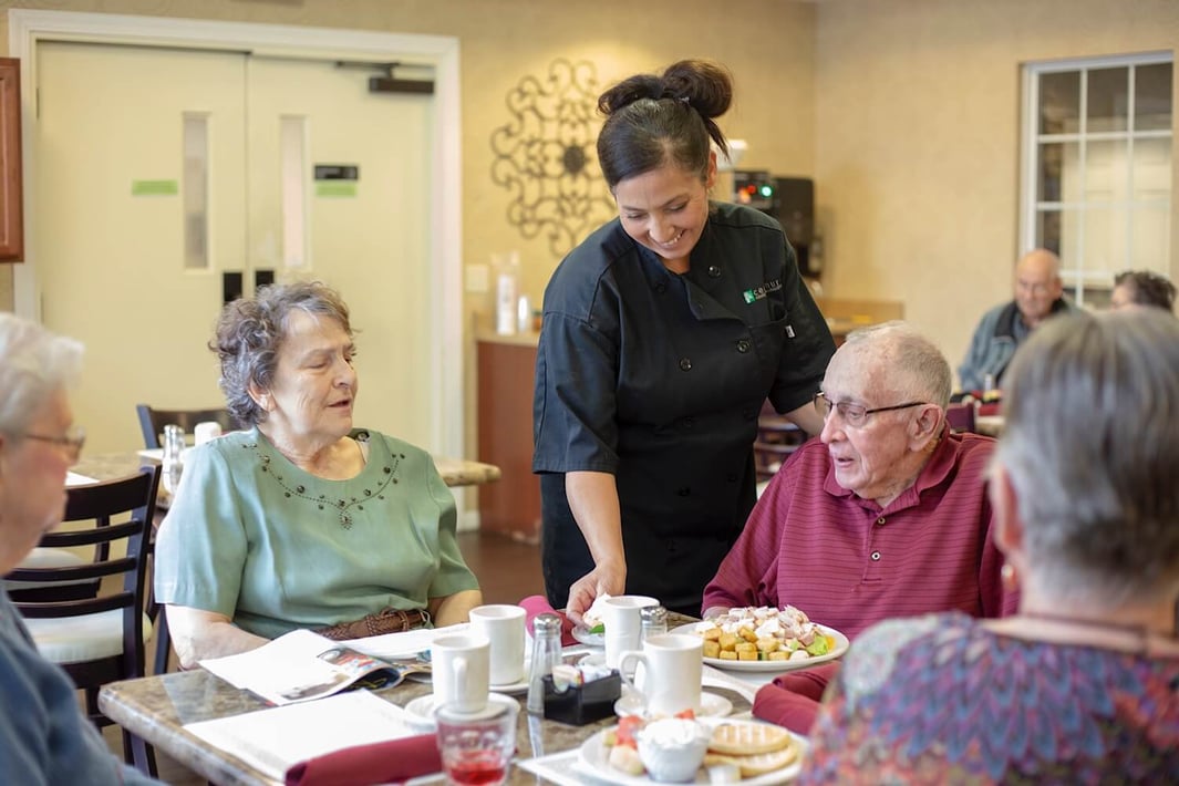 Group of seniors eating together in the community restaurant