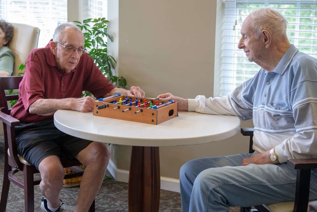 Senior men playing board game