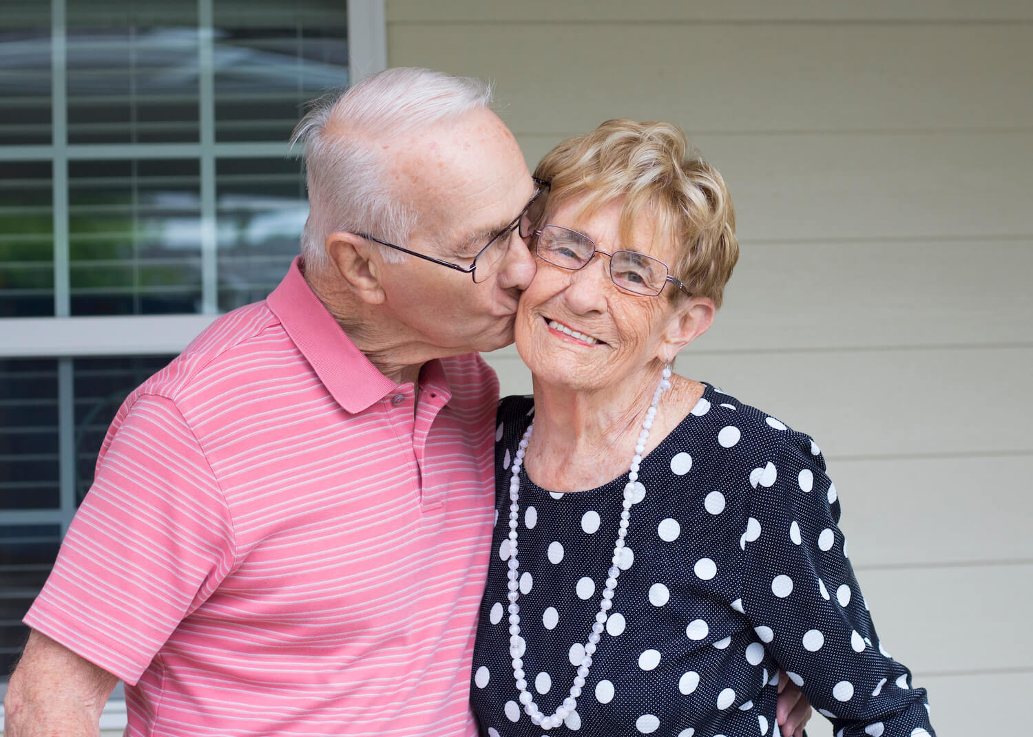 Residents kissing on a porch