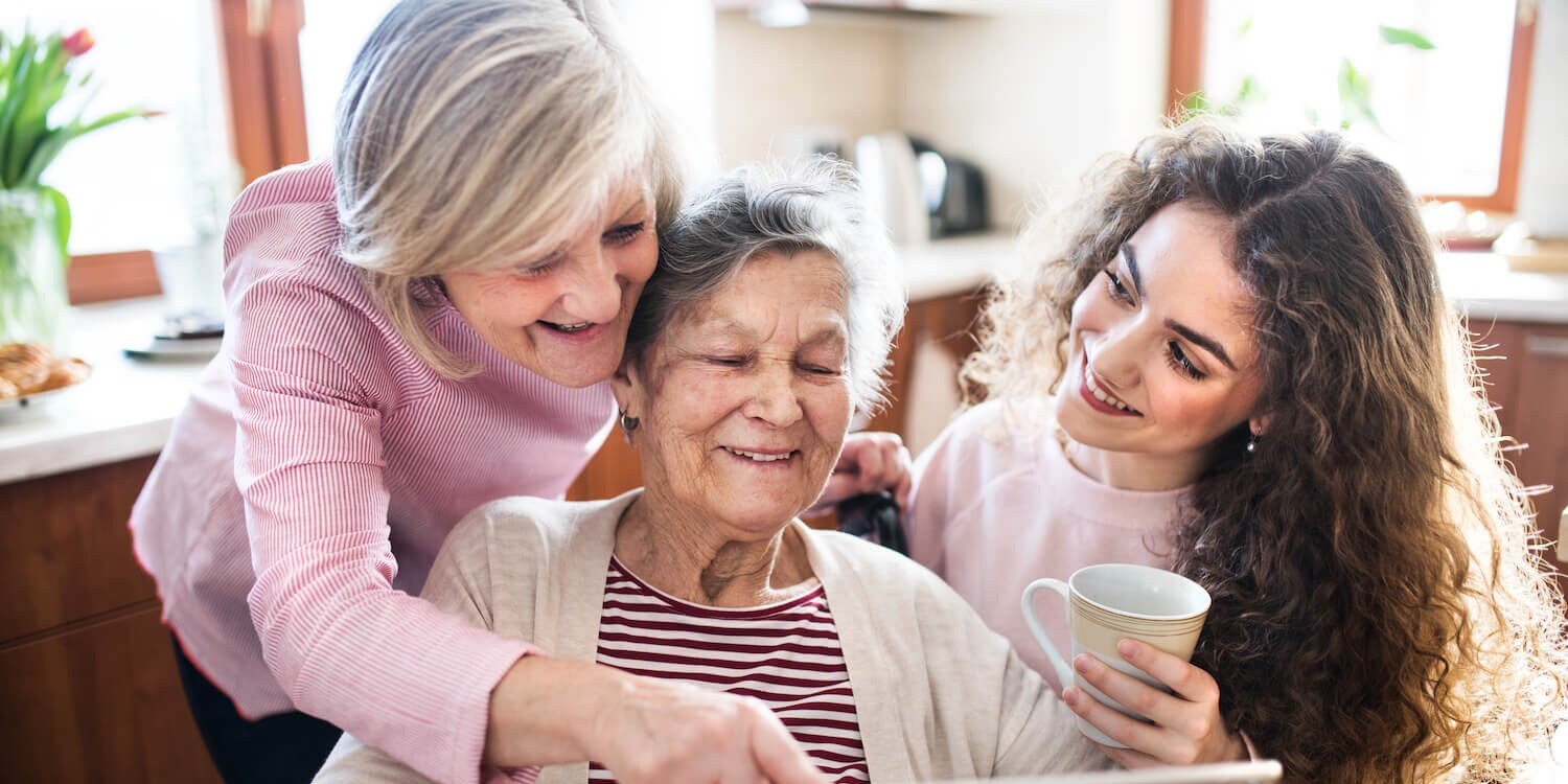Multigenerational family looking at tablet