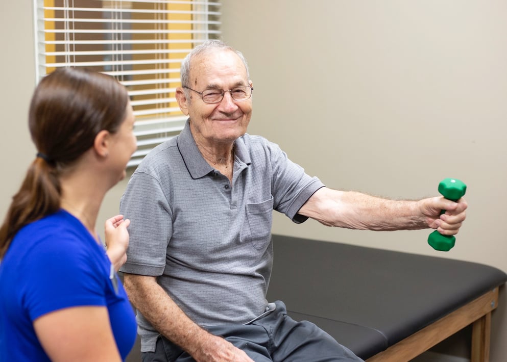 Resident in physical therapy with a caregiver