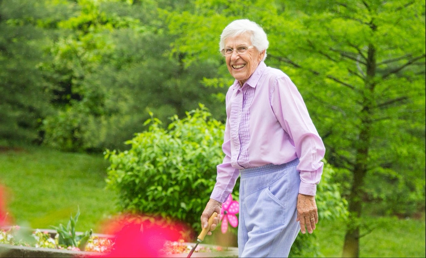 Senior woman walking in the garden