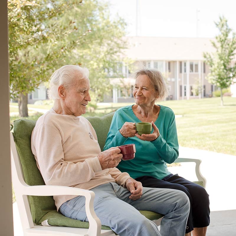 Senior couple enjoying coffee on their patio