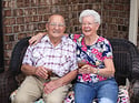 smiling senior couple sitting outdoors