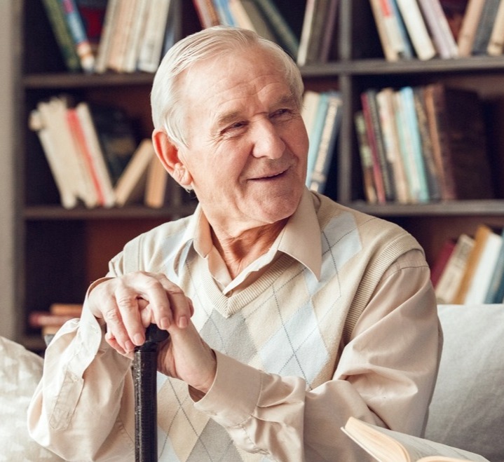 Senior man smiling in library