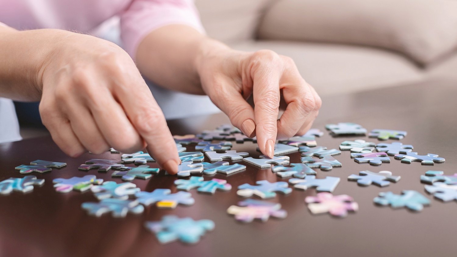 Person playing with jigsaw puzzle