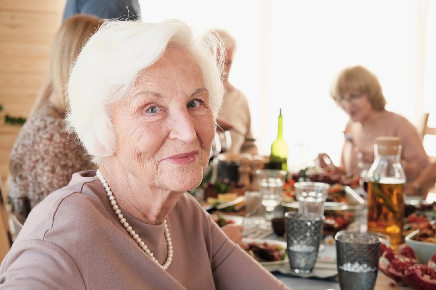 Senior woman sitting at dinner-1261156656