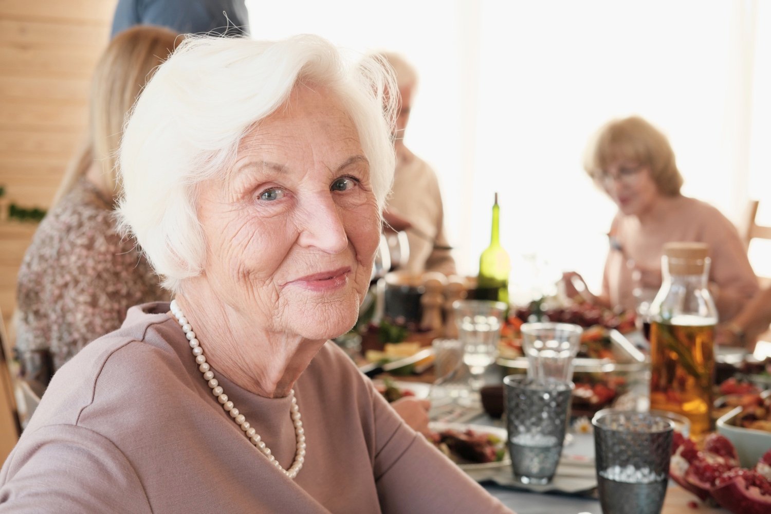Senior woman sitting at dinner-1261156656 Senior woman sitting at dinner-1261156656