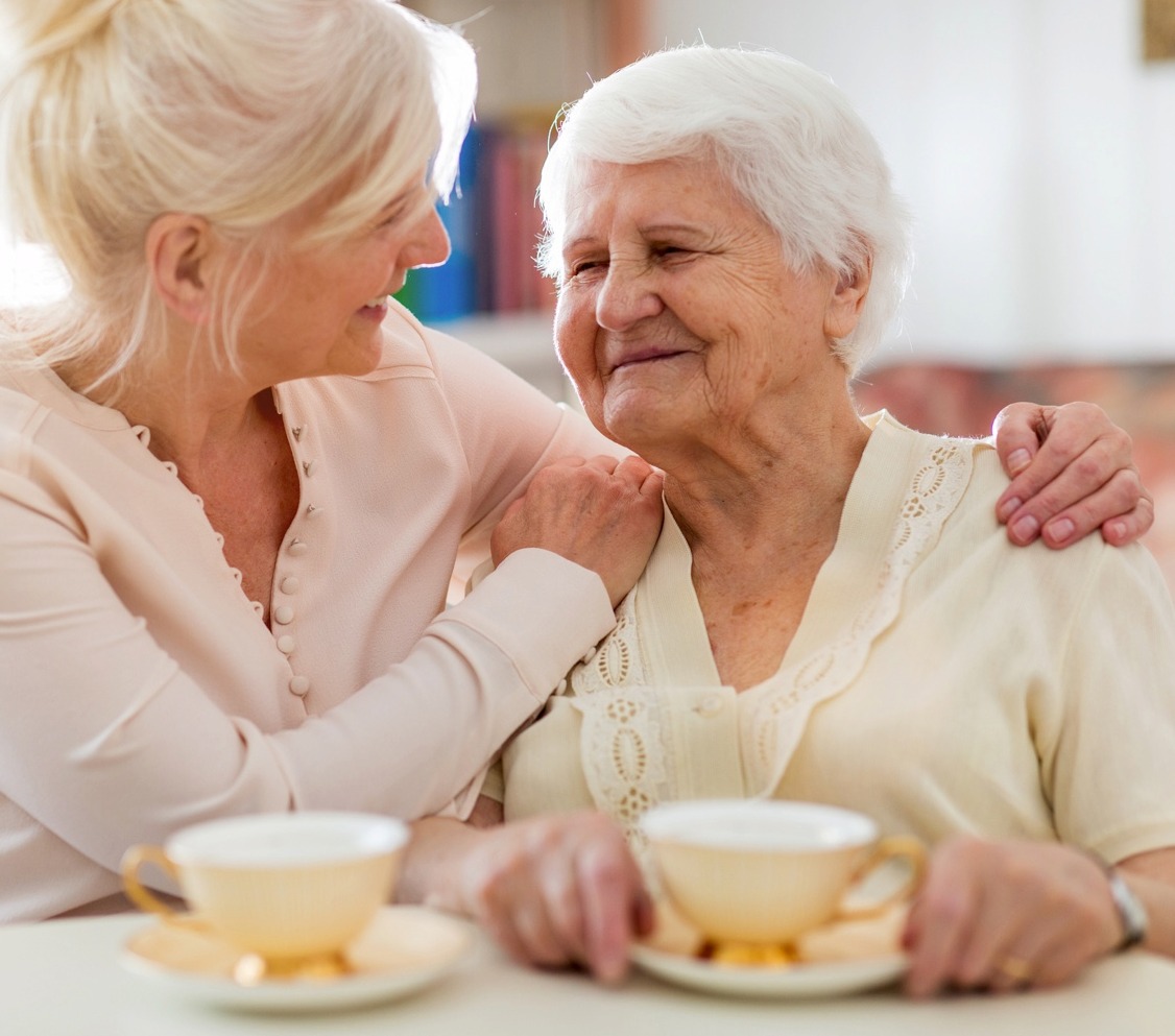 Senior woman spending time with staff member