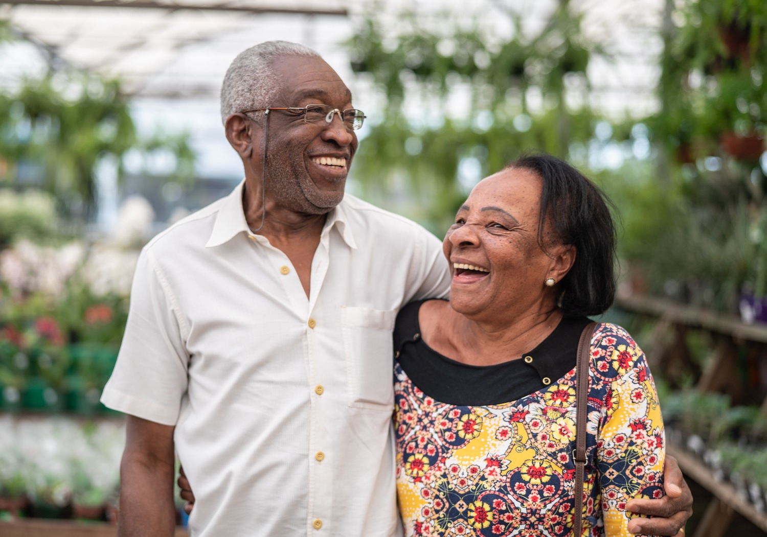 A senior couple laughing and embracing outdoors