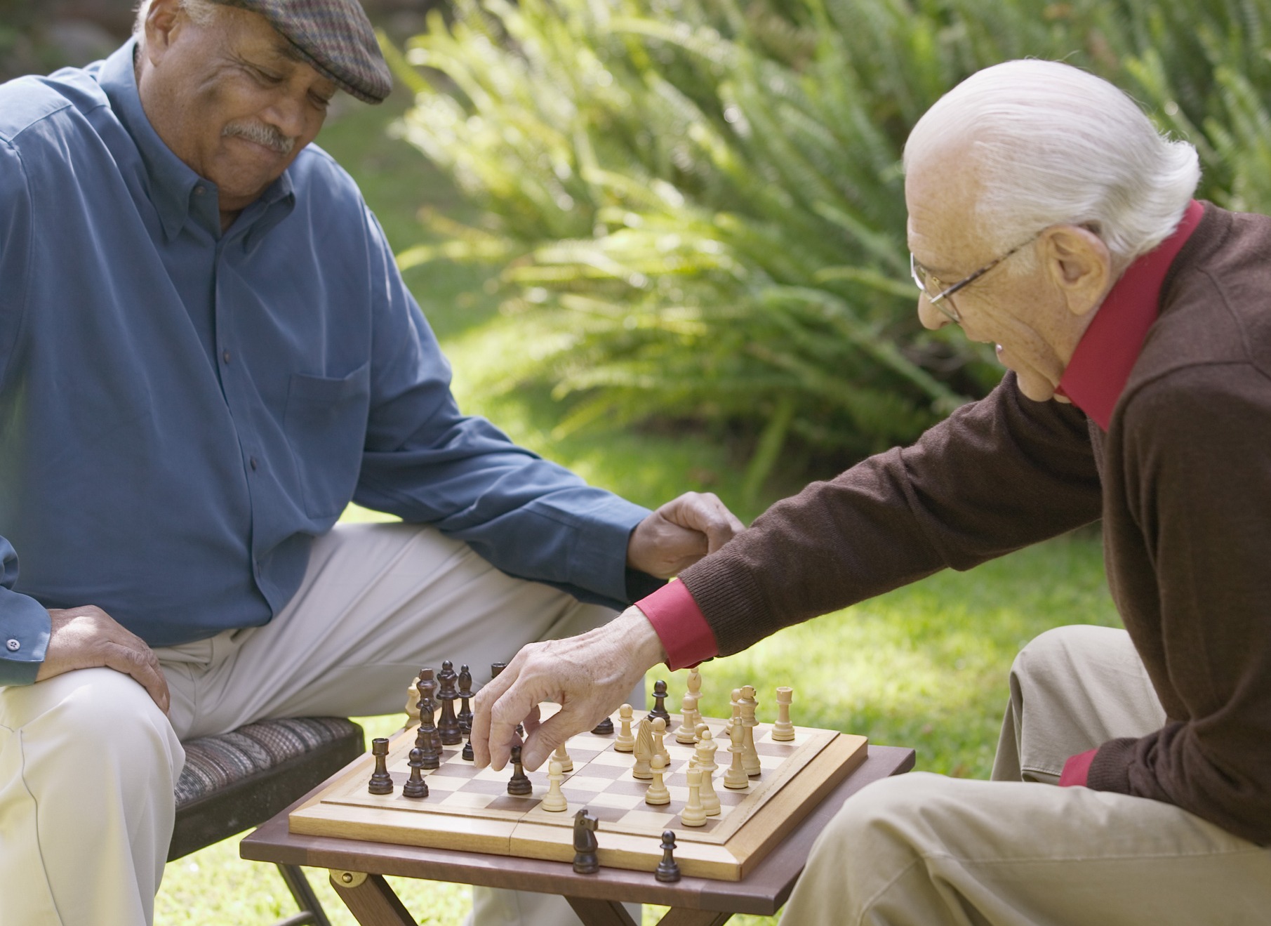 Seniors playing chess outdoors