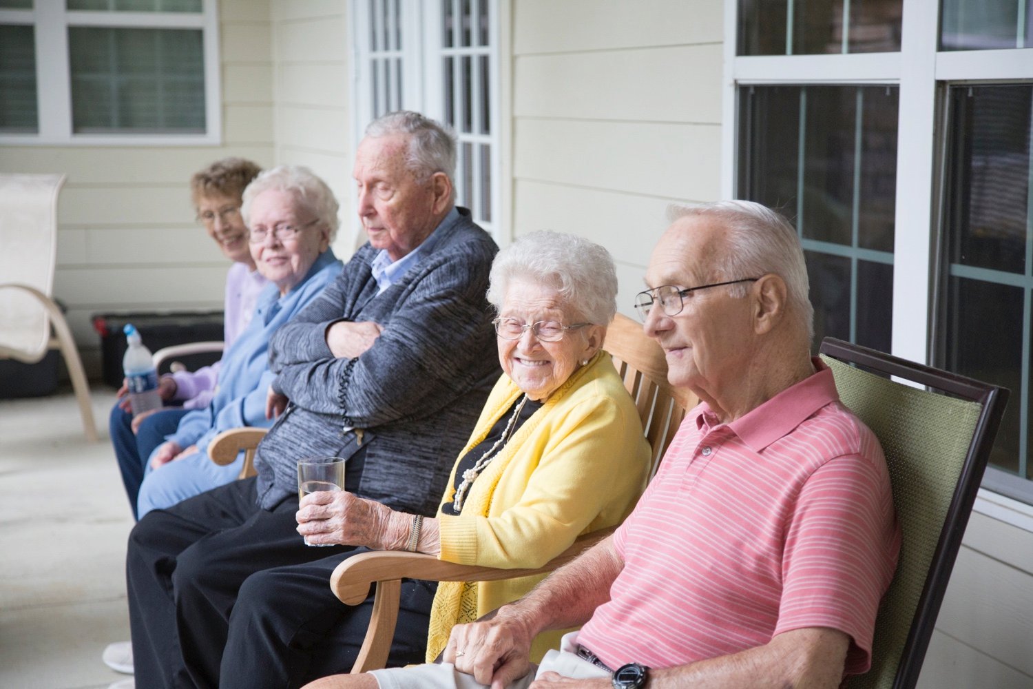 Group of residents sitting together on front porch