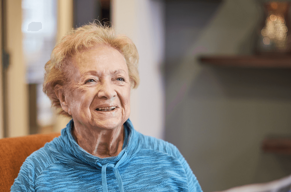 A resident smiling while reading the newspaper 