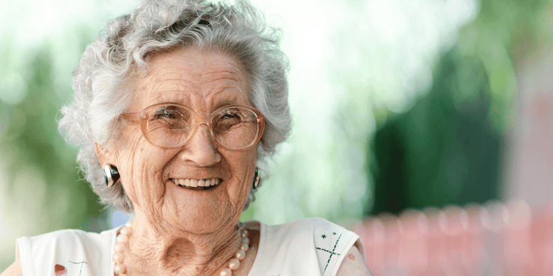 Elderly woman smiling at senior living community
