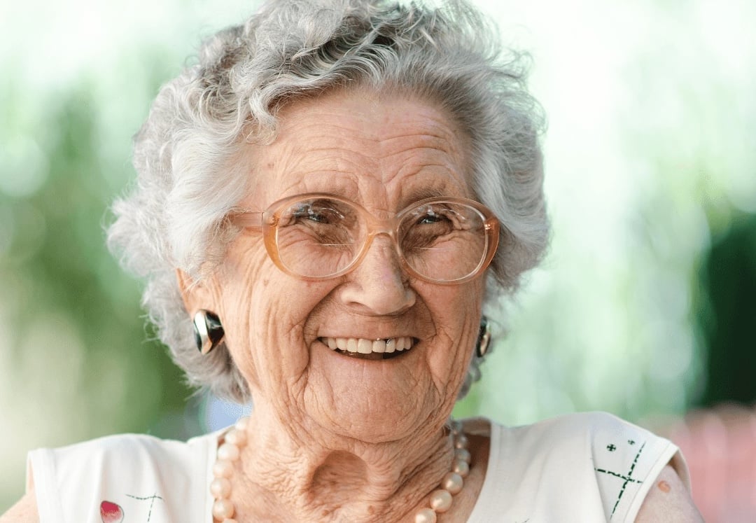 Elderly woman smiling at senior living community