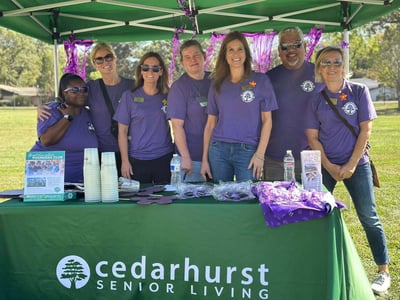 A Cedarhurst team works a booth at the 2025 Walk to End Alzheimer's