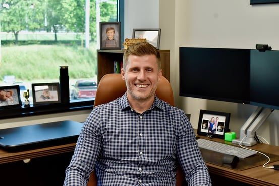 Cedarhurst Senior Living President Almir Sajtovic sits in his office and smiles for the camera.