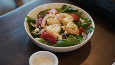 A heart healthy salad served in the dining room of a senior living community.