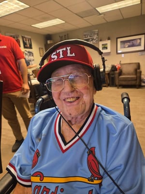 Senior living resident Jim poses for a photo in his brand new St. Louis Cardinals gear.
