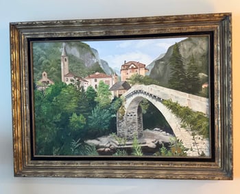 A painting of a stone bridge that leads into a small village surrounded by mountains.