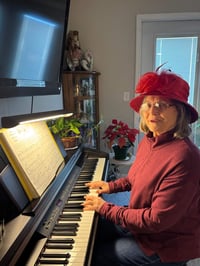 A Cedarhurst of West Plains resident plays the piano in her apartment.