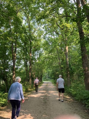 Senior living residents take a stroll along a path at Hoover Forest Preserve in Yorkville, IL.