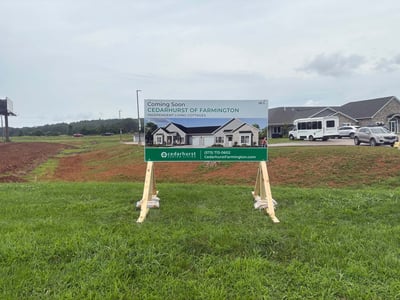 A 'coming soon' sign at the groundbreaking site for Independent Living Cottages at Cedarhurst of Farmington.
