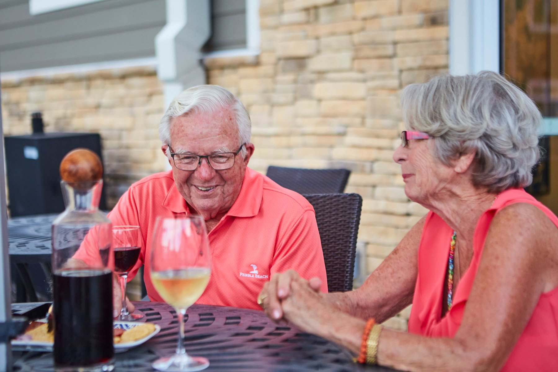 seniors sitting outside enjoying a meal