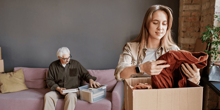 Adult woman packing boxes to prepare senior for moving to a senior living community