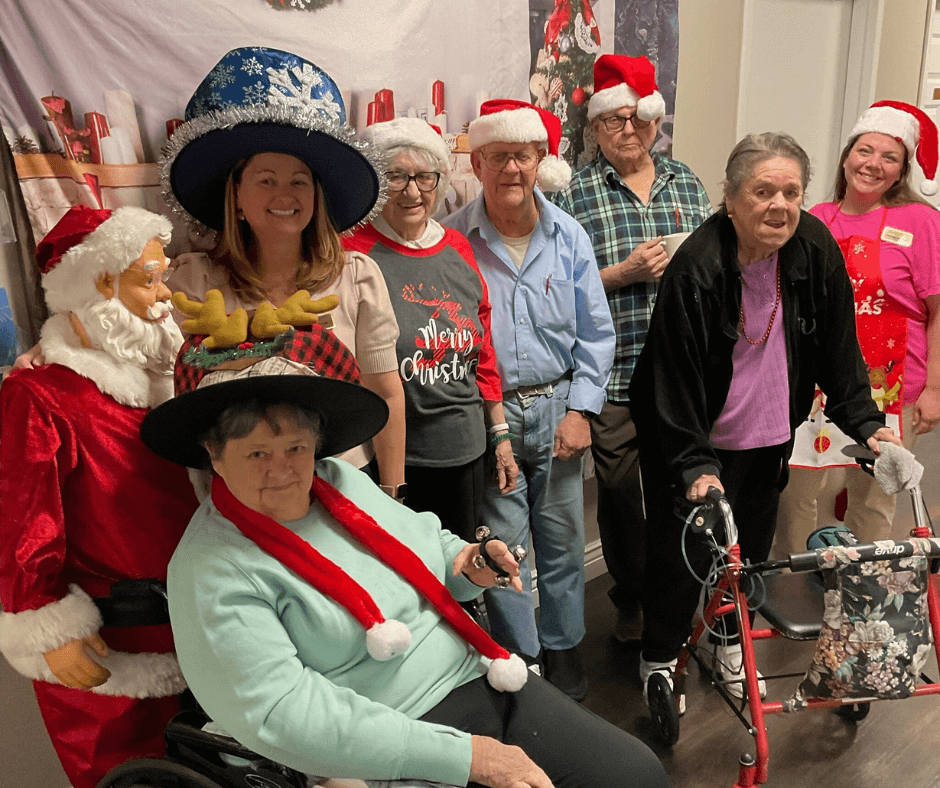 Holidays at Cedarhurst - A group of senior living residents and a community staff member gather for a photo dressed in festive Christmas holiday clothing.