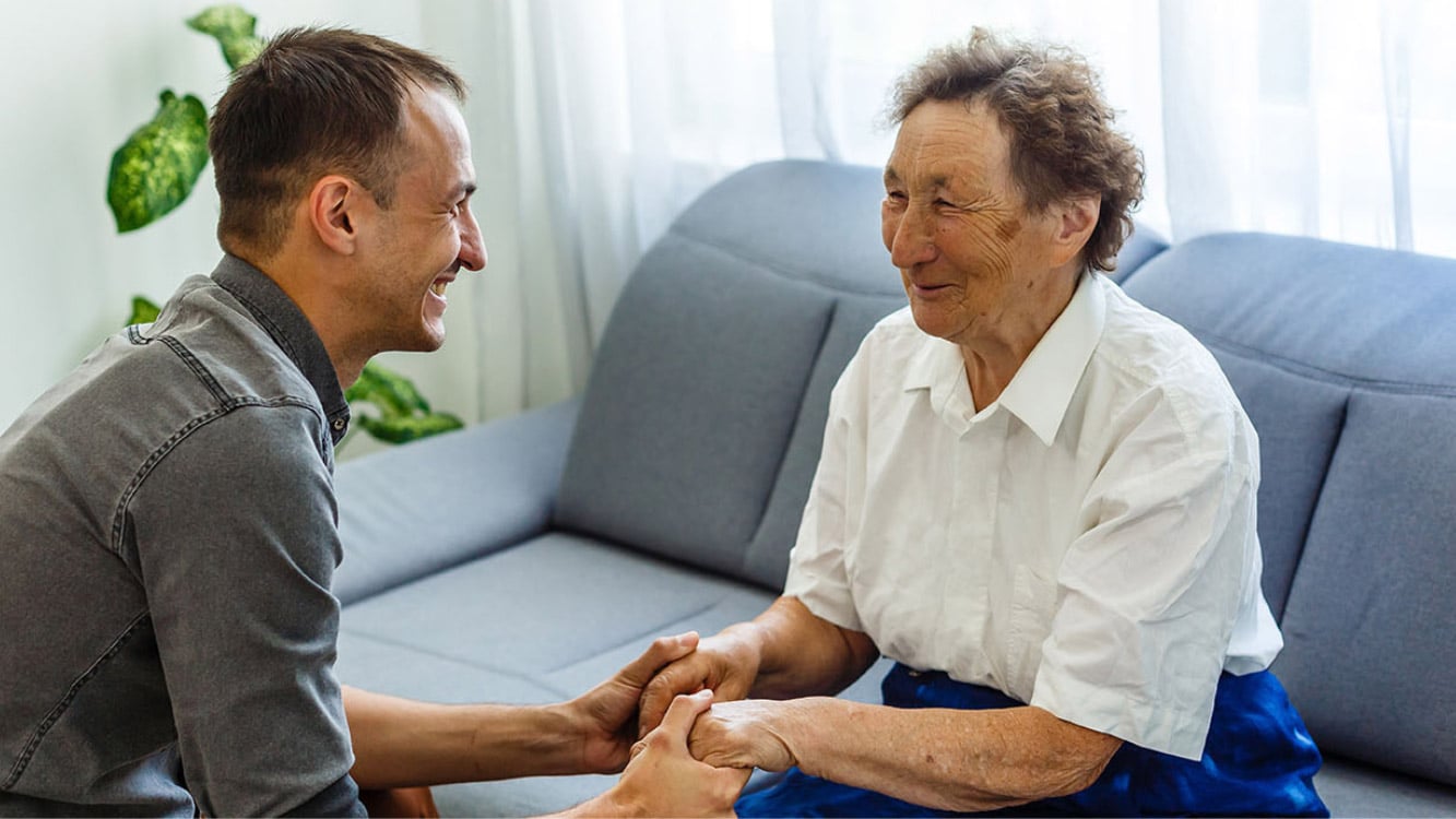 adult son helping senior parent with dementia