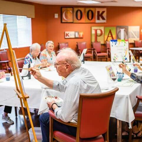 senior residents participating in a painting class