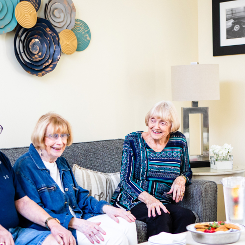 senior women sitting together laughing