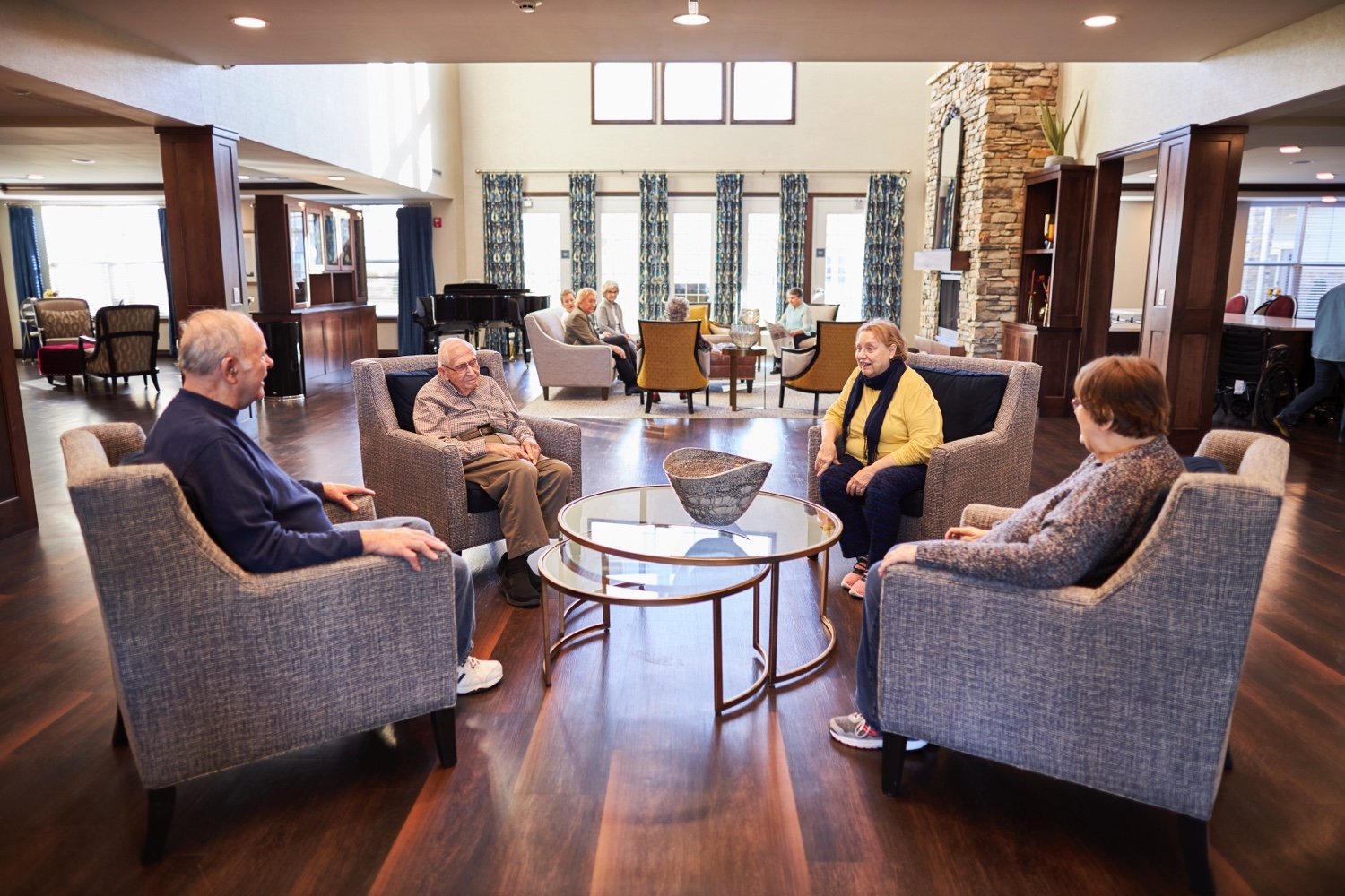 Cedarhurst Blue Springs Seniors socializing in the community living room