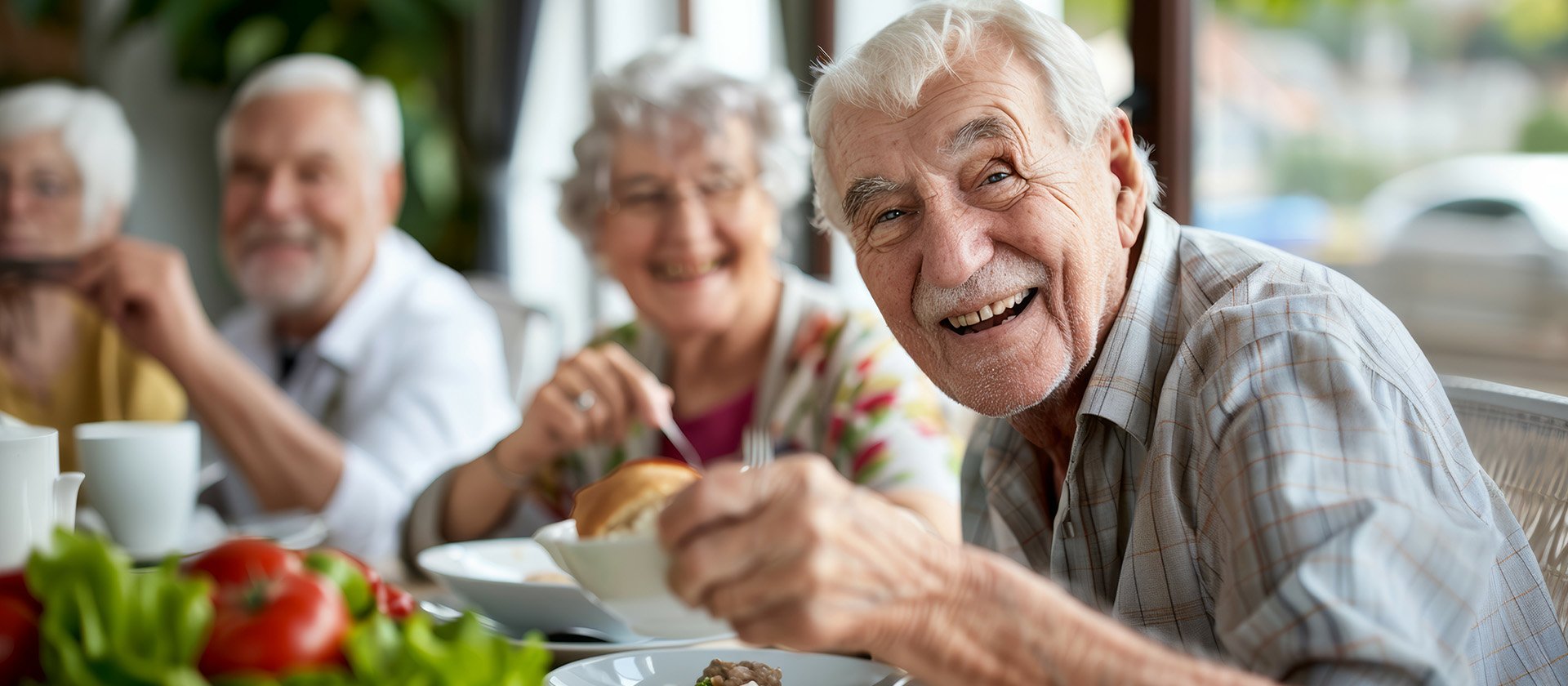Senior living residents enjoying a meal together