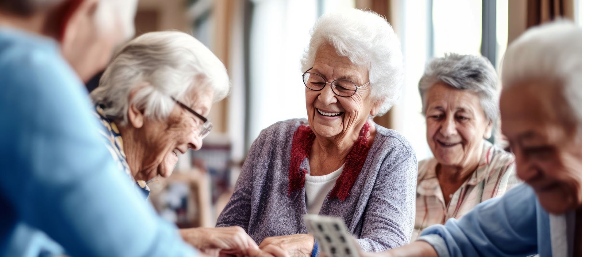 Senior living residents playing a card game