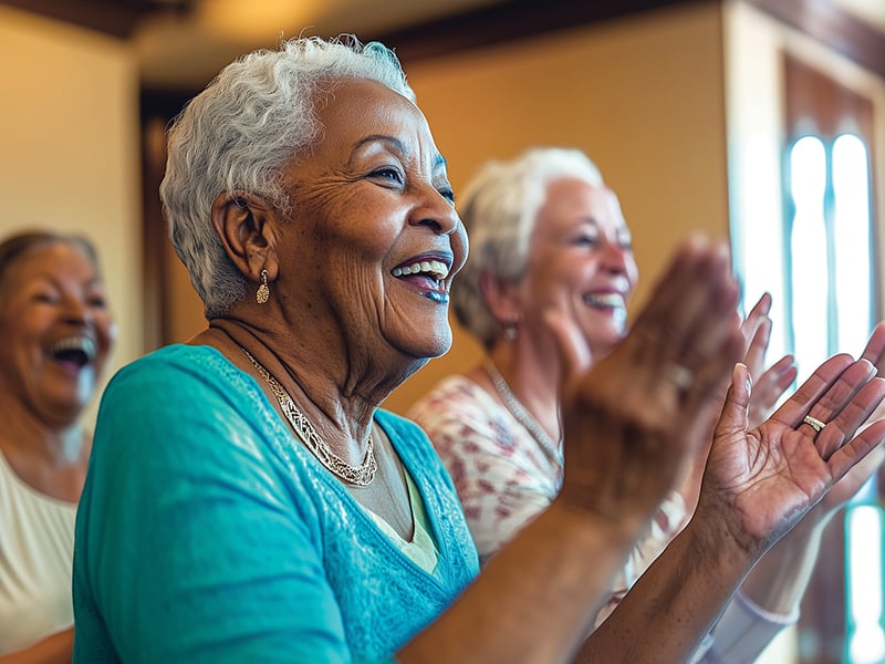 Two assisted living residents potting a plant together