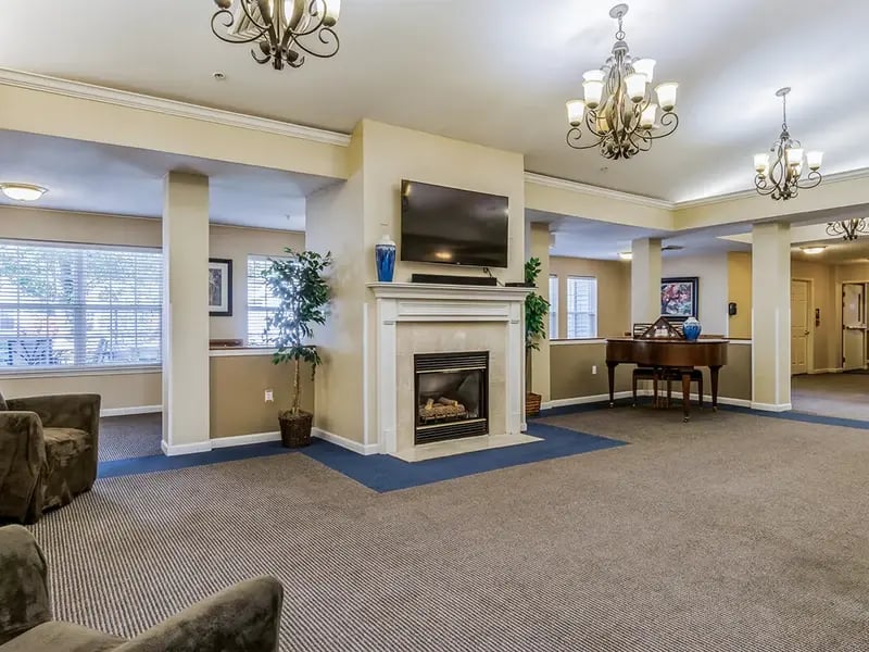 Cedar Creek of Fort Wayne 's cozy common area, complete with a warm fireplace and comfortable seating