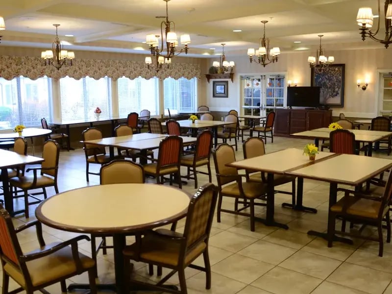 A spacious and bright dining room at Cedar Creek of High Plains, offering comfortable seating for meals