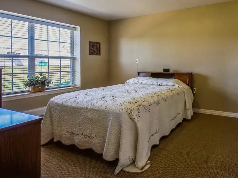 Bedroom of a senior apartment at Cedar Creek of Logansport, designed for comfort and personalization