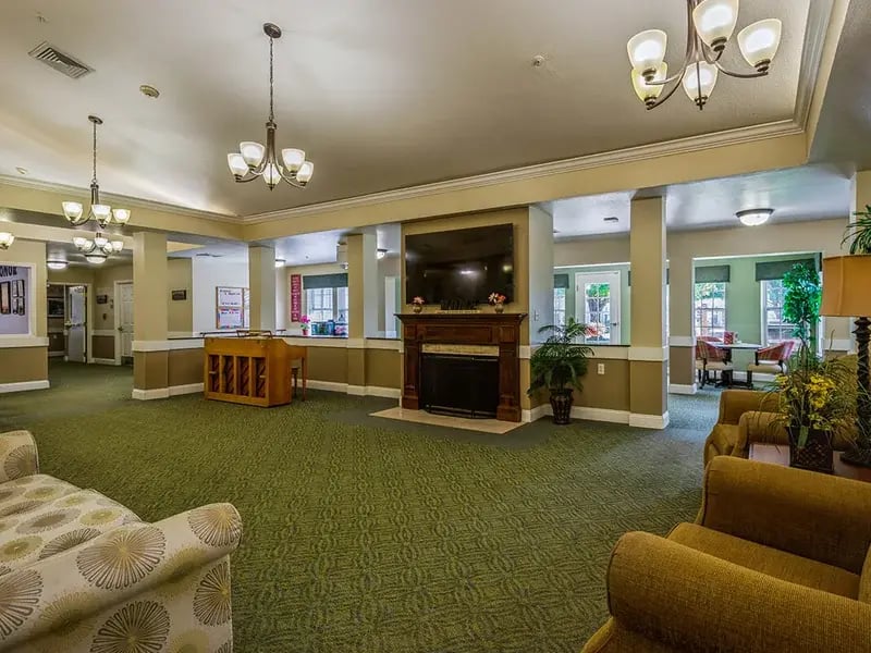 Cedar Creek of Logansport's cozy common area, complete with a warm fireplace and comfortable seating