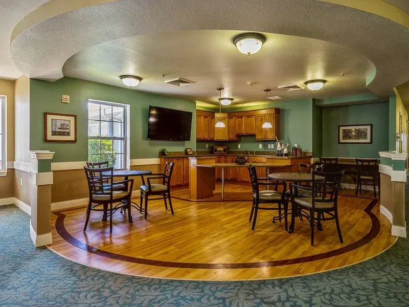 A spacious and bright dining room at Cedar Creek of Logansport, offering comfortable seating for meals