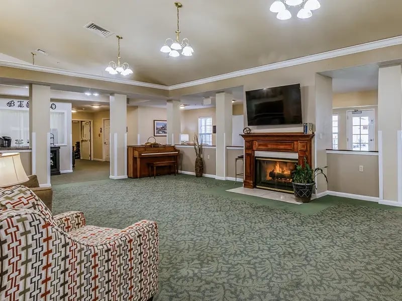 Cedar Creek of Muncie's cozy common area, complete with a warm fireplace and comfortable seating