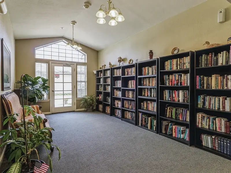 Community common area with books and seating at Cedar Creek of Muncie