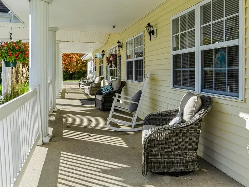 An inviting outdoor area at Cedar Creek of Muncie, showing lush green spaces and paved paths,