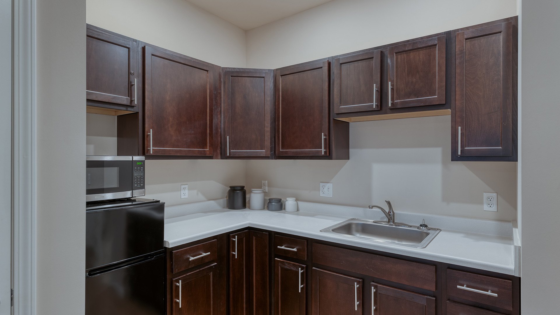 An accessible kitchenette in a senior apartment at Cedarhurst of Arnold, designed for ease of use and independence