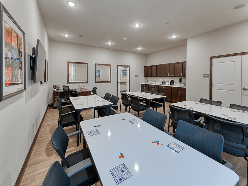 A bright and welcoming activity room at Cedarhurst of Arnold, offering various opportunities for recreation