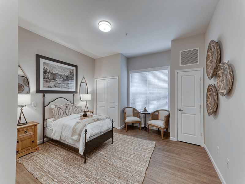 A spacious and comfortable bedroom within a senior apartment at Cedarhurst of Arnold