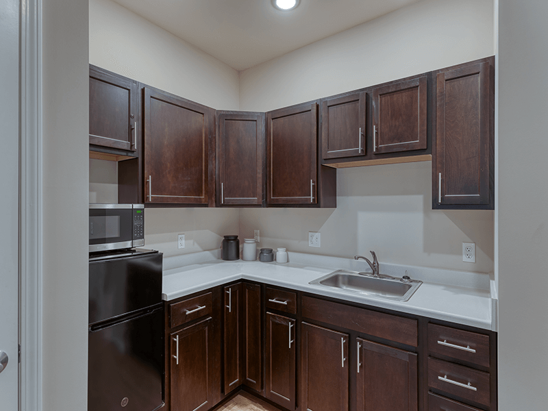 An accessible kitchenette in a senior apartment at Cedarhurst of Arnold, designed for ease of use and independence